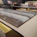 Architectural TV Stand with Sculpted Relief Panels Natural Wood Veneer Open Display Shelves and Soft Ambient Lighting